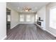 Spacious living room with fireplace, wood floors, and ample lighting at 3216 N Kenwood Ave, Indianapolis, IN 46208