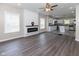 Open-concept living area with adjacent kitchen, fireplace and wood flooring at 3216 N Kenwood Ave, Indianapolis, IN 46208