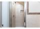 Newly tiled shower with glass door and shampoo niche, offering a spa-like experience and modern convenience at 3216 N Kenwood Ave, Indianapolis, IN 46208