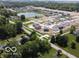 An aerial view of the community featuring newly built homes and a pond at 3321 Godby Dr, Sheridan, IN 46069