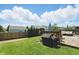 Fenced backyard features a grill, a wooden deck with outdoor seating, and mature trees at 3341 Enclave Xing, Greenwood, IN 46143
