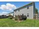 Home exterior showcasing a backyard with a deck, grill, and a well-kept lawn at 3341 Enclave Xing, Greenwood, IN 46143