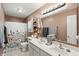 Bright bathroom with double sinks, neutral colors, and a floral shower curtain at 3341 Enclave Xing, Greenwood, IN 46143