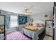 Bright bedroom featuring ceiling fan, large bed, and accent decor at 3341 Enclave Xing, Greenwood, IN 46143
