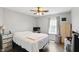 Bright bedroom featuring hardwood floors, a white comforter, and a ceiling fan at 3341 Enclave Xing, Greenwood, IN 46143