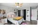 Bedroom with gray walls, ceiling fan, large bed, and plenty of natural light at 3341 Enclave Xing, Greenwood, IN 46143
