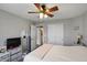 Neutral bedroom with wood floors, ceiling fan, and view of en-suite bathroom at 3341 Enclave Xing, Greenwood, IN 46143