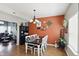 Traditional dining room features wood floors, designer paint and decor, and a modern chandelier at 3341 Enclave Xing, Greenwood, IN 46143