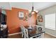 Stylish dining room with a modern light fixture, accent wall, and beautiful decor at 3341 Enclave Xing, Greenwood, IN 46143