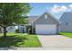 Charming home with a well-maintained lawn, inviting curb appeal, and a two-car garage at 3341 Enclave Xing, Greenwood, IN 46143