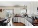 Bright kitchen features a stainless dishwasher, undermount sink, and white cabinetry at 3341 Enclave Xing, Greenwood, IN 46143