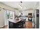 Updated kitchen features white cabinets, stainless appliances, and a center island with seating at 3341 Enclave Xing, Greenwood, IN 46143