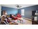 Comfortable living room with leather furniture, a ceiling fan, and natural light at 3341 Enclave Xing, Greenwood, IN 46143