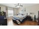 Cozy main bedroom with wood-look floors, ceiling fan, and an ensuite bath at 3341 Enclave Xing, Greenwood, IN 46143