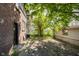 The backyard has a mix of shade and sunlight, a tree and a fence at 3370 N New Jersey St, Indianapolis, IN 46205