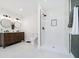 Modern bathroom featuring wood vanity with double sinks and a tiled walk-in shower at 3370 N New Jersey St, Indianapolis, IN 46205