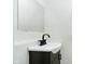 Modern bathroom features a sleek black faucet and mirror, complementing the clean, white interior at 3370 N New Jersey St, Indianapolis, IN 46205