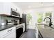 Bright, modern kitchen with stainless steel appliances and ample counter space near a large window at 3370 N New Jersey St, Indianapolis, IN 46205
