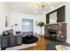 Cozy living room featuring a decorative fireplace, comfortable seating, and warm hardwood floors at 3370 N New Jersey St, Indianapolis, IN 46205