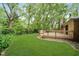 Enjoy the outdoors on this home's deck surrounded by green grass and trees at 3698 E 106Th St, Carmel, IN 46033