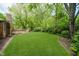 Well maintained backyard offers wooden deck, brick home exterior, and lush green lawn at 3698 E 106Th St, Carmel, IN 46033