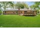 Spacious backyard featuring lush green grass and inviting wooden deck on a brick home at 3698 E 106Th St, Carmel, IN 46033