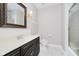 Traditional bathroom offers framed mirror, dark vanity, shower, and tiled flooring at 3698 E 106Th St, Carmel, IN 46033