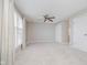 Bright primary bedroom featuring neutral walls, carpet, ceiling fan, and windows at 3698 E 106Th St, Carmel, IN 46033