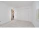 Bright bedroom features fresh paint, neutral carpet, closet, and open door to bathroom at 3698 E 106Th St, Carmel, IN 46033