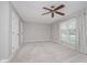 Bright bedroom featuring neutral walls, carpet, ceiling fan, and windows at 3698 E 106Th St, Carmel, IN 46033