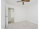 An open doorway creates flow from this neutral bedroom with fan to hallway at 3698 E 106Th St, Carmel, IN 46033