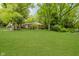Well-manicured front yard with mature trees and landscaping surrounding a traditional-style home at 3698 E 106Th St, Carmel, IN 46033