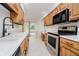 Kitchen features stainless steel appliances, white countertops, and wood cabinets with a sink overlooking backyard at 3698 E 106Th St, Carmel, IN 46033