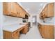 Galley kitchen featuring white countertops, stainless steel appliances, and wood cabinets at 3698 E 106Th St, Carmel, IN 46033