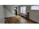 Bright living room features wood-look flooring, a staircase, and ample natural light from the windows at 3848 Spann Ave, Indianapolis, IN 46203