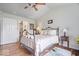 Cozy bedroom boasts wood floors, a wrought iron bed, a vaulted ceiling, and a soothing color palette at 4134 Bella Ct, Indianapolis, IN 46237
