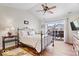 Bedroom features a wrought iron bed, wood floors, vaulted ceiling, and sliding glass doors to the patio at 4134 Bella Ct, Indianapolis, IN 46237