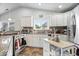Well-lit kitchen featuring stainless steel appliances and a kitchen island at 4134 Bella Ct, Indianapolis, IN 46237