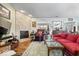 Spacious living room with a stone fireplace, open layout, and seamless flow to dining area at 4134 Bella Ct, Indianapolis, IN 46237