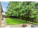 Landscaped backyard features a fire pit, lush lawn, and mature trees for privacy at 436 Maria Dr, Greenwood, IN 46143