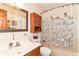 Functional bathroom with wooden vanity, framed mirror, and a shower with cat-themed curtain at 436 Maria Dr, Greenwood, IN 46143