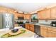 Well-lit kitchen featuring wooden cabinets, stainless steel appliances, and a cozy dining area at 436 Maria Dr, Greenwood, IN 46143