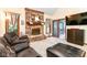 Comfortable living room featuring a brick fireplace, cozy seating, and access to outdoor spaces at 436 Maria Dr, Greenwood, IN 46143