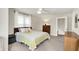 Bedroom featuring neutral colored walls, a wooden dresser, and a ceiling fan with doorway leading to stairs at 4527 Central Ave, Indianapolis, IN 46205