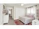 Bedroom with white walls, red rug, white bed frame, white trim, and pink decor at 4527 Central Ave, Indianapolis, IN 46205