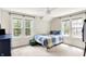 Bedroom with blue dresser, gray carpet, ceiling fan, and windows providing ample natural light at 4527 Central Ave, Indianapolis, IN 46205