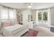Bright bedroom with a white bed frame, white walls, a vanity, and plenty of natural light at 4527 Central Ave, Indianapolis, IN 46205