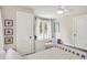 Bedroom with white walls, white trim, a white desk, a ceiling fan, and plenty of natural light at 4527 Central Ave, Indianapolis, IN 46205
