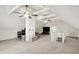 Open bonus room with exposed beams, carpet flooring, and white painted brick details at 4527 Central Ave, Indianapolis, IN 46205