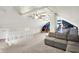 Spacious carpeted bonus room with staircase and modern gray sofa for relaxing and entertaining at 4527 Central Ave, Indianapolis, IN 46205